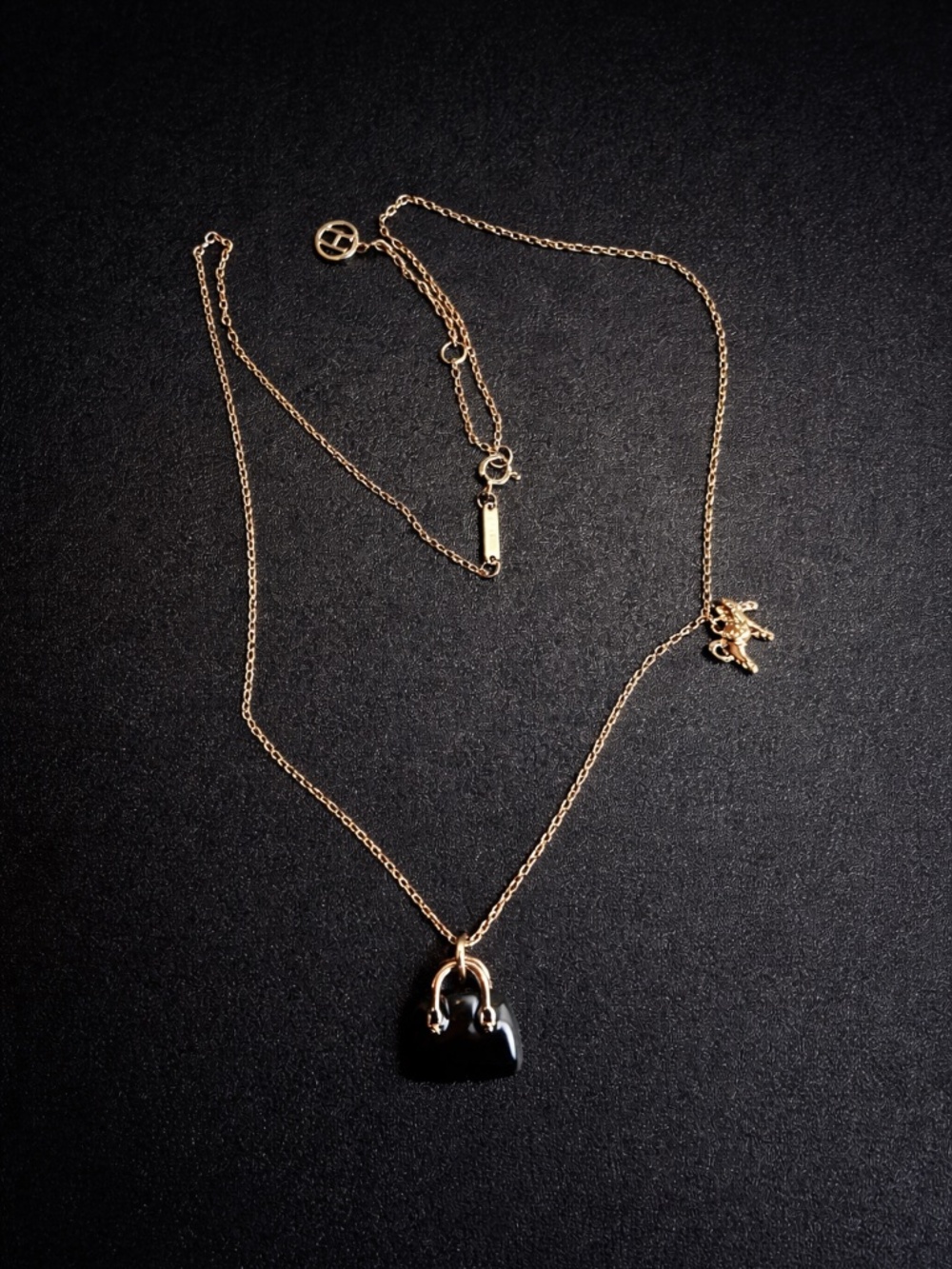 Rose gold necklace with horse and bag charm